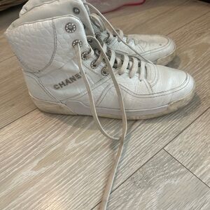 CHANEL Quilted White High-Top Sneakers